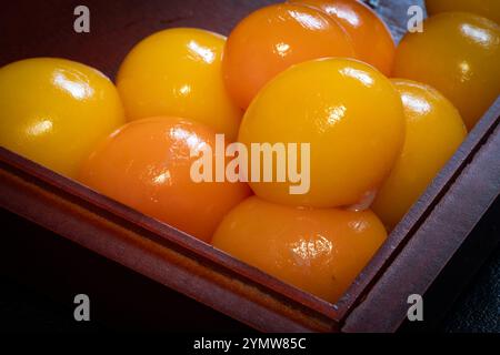 Fresh unlaid chicken eggs in a wooden tray container Stock Photo