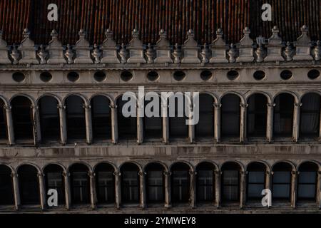 The long Arcade, known as the Procuratie Vecchie on the north side of St Mark's Square, piazzetta facade - Doges palace in Venice, Italy Stock Photo