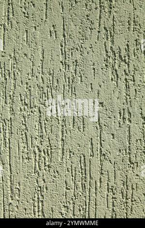 Green faded surface, texture, background. Decorated surface with vertical embossed strokes or stripes. Pale, light-green abstract wall surface Stock Photo