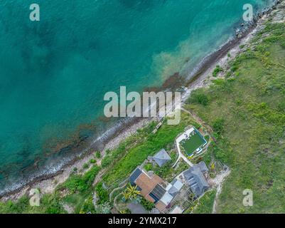 Aerial view of a beach with turquoise water, rows of sun loungers and ...