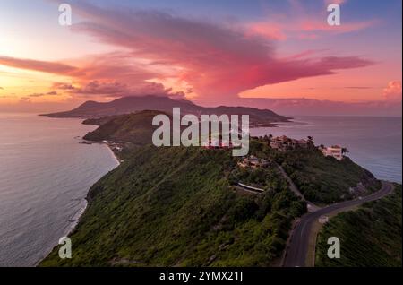 Luxury mountain top vacation houses on St Kitts with colorful sunset over the Caribbean Sea Stock Photo