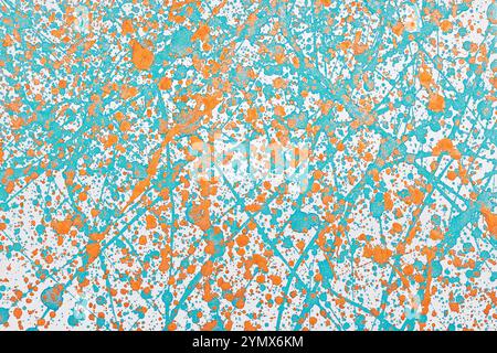 Turquoise blue and orange paint splashes on a white surface. Abstract background. Stock Photo