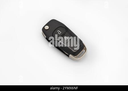 Close-up of a modern car key with remote control on a white background, ideal for automotive, technology, or security-themed projects. Stock Photo