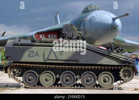 Vintage, historic preserved military history on display. Former Royal Air Force Avro Vulcan bomber XL426 and British Army Alvis FV103 Spartan APC Stock Photo