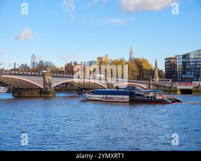 Uber Boat on the river Thames passing through Lambeth Bridge, Westminster, London, UK Stock Photo