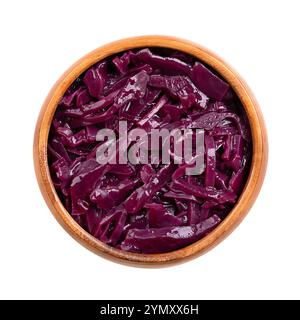Braised red cabbage in a wooden bowl. Traditional German side dish of intense purple color, made of sliced cabbage, apple, wine vinegar. Stock Photo