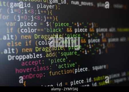 Colorful and complex JavaScript code displayed on a computer screen, highlighting various syntax elements. Focus on programming details and coding str Stock Photo