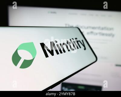 Stuttgart, Germany, 03-13-2024: Mobile phone with logo of American documentation platform company Mintlify Inc. in front of website. Focus on center-l Stock Photo