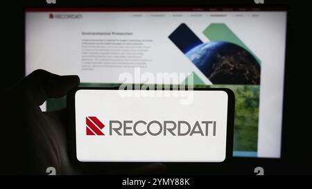 Stuttgart, Germany, 06-01-2024: Person holding cellphone with logo of Italian pharmaceuticals company Recordati S.p.A. in front of business webpage. F Stock Photo