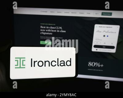 Stuttgart, Germany, 06-05-2024: Person holding smartphone with logo of US contract management software company Ironclad Inc. in front of website. Focu Stock Photo