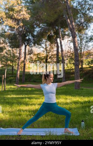young woman practicing yoga in the park Stock Photo