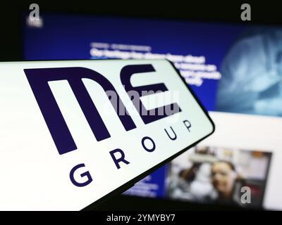 Stuttgart, Germany, 03-25-2024: Cellphone with logo of British vending machine company ME Group International plc in front of business website. Focus Stock Photo