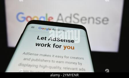 Stuttgart, Germany, 07-17-2024: Smartphone with website of online advertising program Google AdSense in front of business logo. Focus on top-left of p Stock Photo