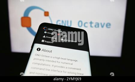 Stuttgart, Germany, 03-13-2024: Mobile phone with website of scientific programming language GNU Octave in front of logo. Focus on top-left of phone d Stock Photo