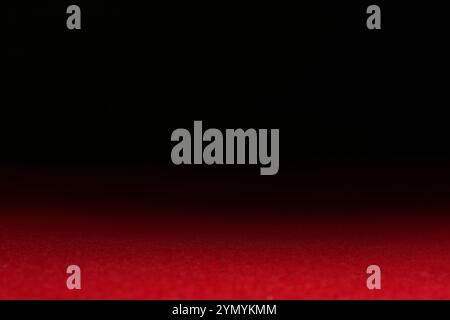 Red textured surface against dark background, selective focus Stock Photo