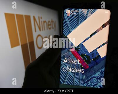 Stuttgart, Germany, 03-25-2024: Person holding cellphone with website of asset management company Ninety One Limited in front of business logo. Focus Stock Photo