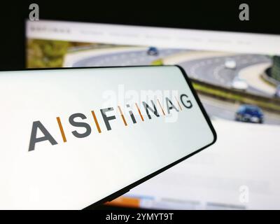 Stuttgart, Germany, 06-11-2024: Smartphone with logo of Austrian motorway infrastructure company ASFINAG in front of business website. Focus on center Stock Photo