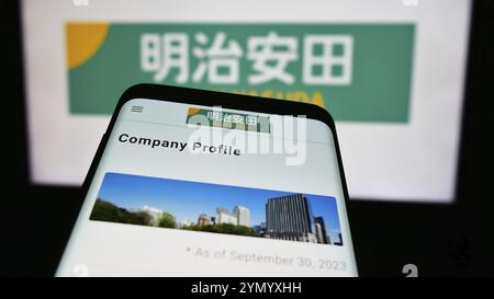 Stuttgart, Germany, 04-12-2024: Mobile phone with website of Japanese business Meiji Yasuda Life Insurance Company in front of business logo. Focus on Stock Photo