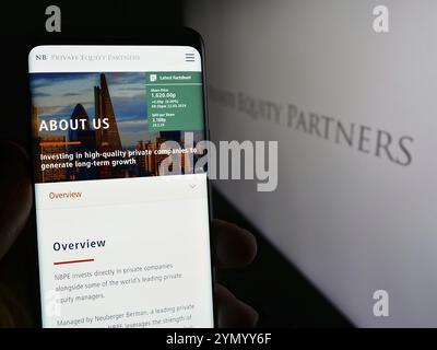 Stuttgart, Germany, 03-25-2024: Person holding cellphone with webpage of British company NB Private Equity Partners Ltd. (NBPE) with logo. Focus on ce Stock Photo