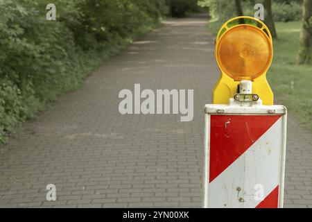 Construction site, white red barrier with warning light Stock Photo
