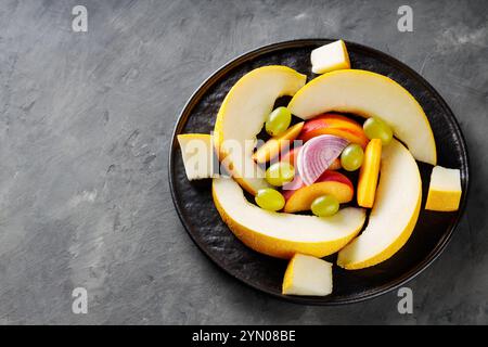 Assorted Fresh Fruits and Vegetables on Black Plate, Dark Gray Background, Top View, Copy Space Stock Photo