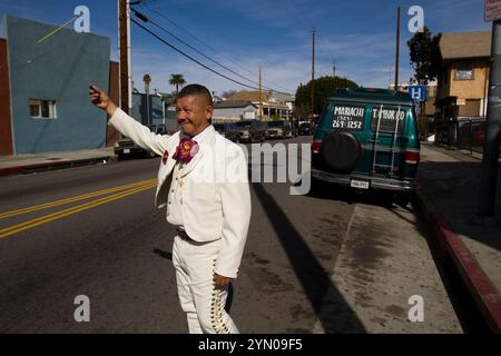 Mariachis gather at Mariachi Plaza on a Sunday in hopes of being hired to play their music at a party or a restaurant. Stock Photo