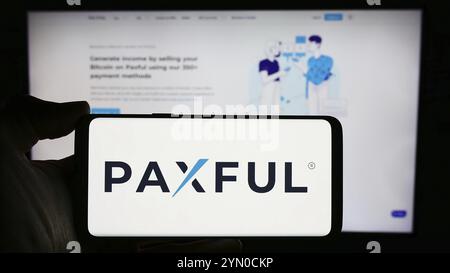 Stuttgart, Germany, 03-19-2024: Person holding cellphone with logo of US crypto currency company company Paxful Inc. in front of business webpage. Foc Stock Photo