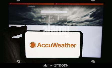 Stuttgart, Germany, 06-06-2024: Person holding cellphone with logo of US weather forecasting company AccuWeather Inc. in front of business webpage. Fo Stock Photo