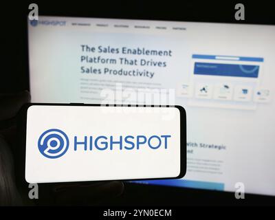 Stuttgart, Germany, 06-01-2024: Person holding smartphone with logo of US sales enablement platform company Highspot Inc. in front of website. Focus o Stock Photo