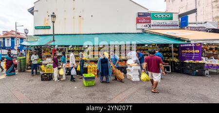 A panoramic image of Indian people selling and buying fresh fruit and vegetables from a stall in Campbell Lane, Little India, in Singapore Stock Photo