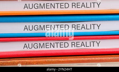 The concept of technology and development. Phrase, words, text AUGMENTED REALITY close-up on the ends of the notebooks Stock Photo