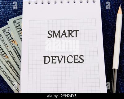 The concept of technology and development. Phrase, words, text SMART DEVICES on a blank sheet of notepad Stock Photo