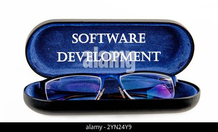 The concept of technology and development. Phrase, words, text SOFTWARE DEVELOPMENT written on the open case of the glasses case Stock Photo