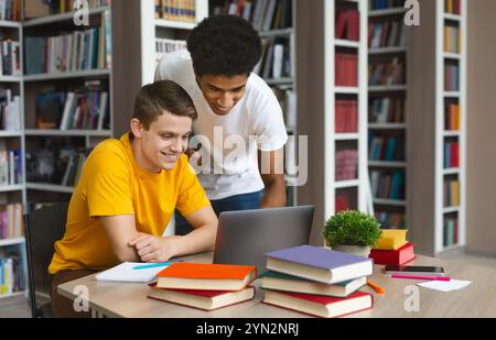 Smart black guy helping his classmate with homework Stock Photo