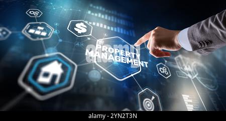 Businessman pressing PROPERTY MANAGEMENT button on virtual screens Stock Photo