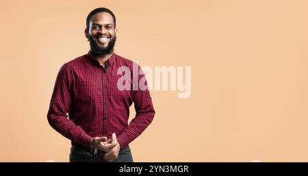 Smiling afro man posing on orange background Stock Photo
