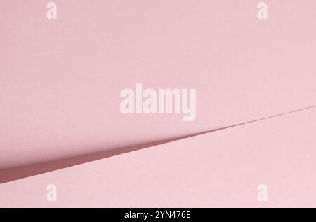 Pink paper background with a soft matte texture and subtle gradient. Minimalistic and elegant design featuring delicate tones and gentle creases. Perf Stock Photo