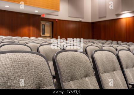 Close up photo of empty light brown, tan theater, auditorium seats, chairs. Stock Photo