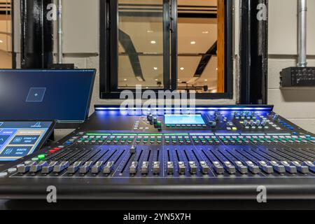 Mixing console, sound board, equipment in an auditorium, theater sound / projection booth. Stock Photo
