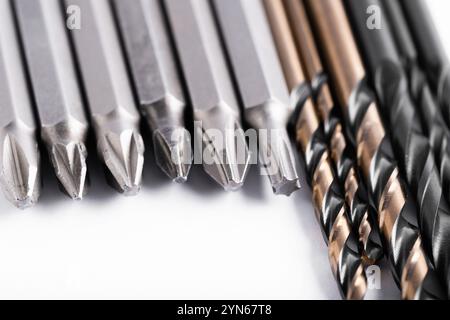 Set of different bits for electric screwdriver and drills for metal and wood. Closeup on white background Stock Photo