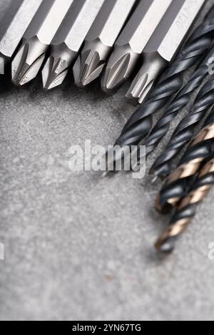 Set of drill bits on grey background. Close up. Selective focus Stock Photo