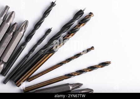 Set of various drill bits on white background. Top view Stock Photo