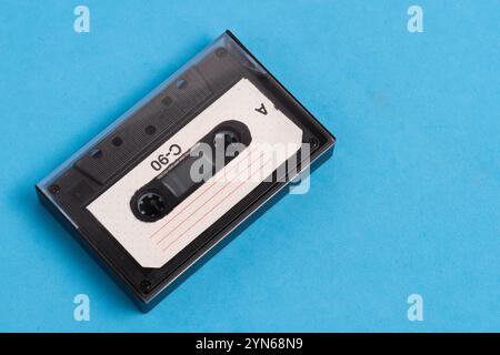 Old vintage audio cassette on blue background Stock Photo