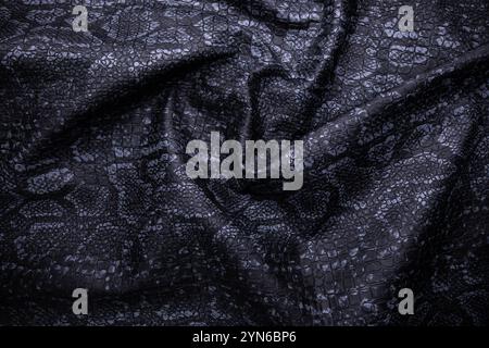 Vegan faux Snakeskin leather texture. minimalist and elegant crumple textile. simple dark black backdrop Stock Photo