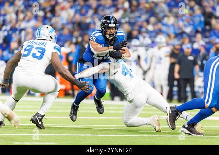 Indianapolis, Indiana, USA. 24th Nov, 2024. Indianapolis Colts running back Jonathan Taylor (28) runs with the ball as Detroit Lions linebacker Malcolm Rodriguez (44) attempts to make the tackle during NFL game action at Lucas Oil Stadium in Indianapolis, Indiana. John Mersits/CSM (Credit Image: © John Mersits/Cal Sport Media). Credit: csm/Alamy Live News Stock Photo