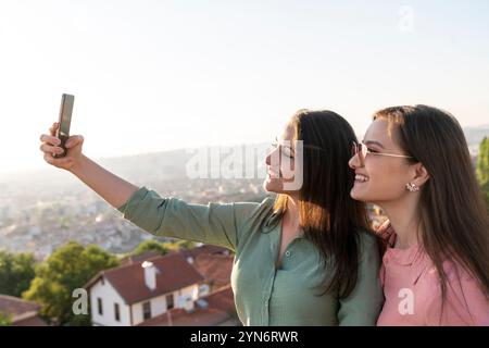Two young women taking selfie together in the city Stock Photo