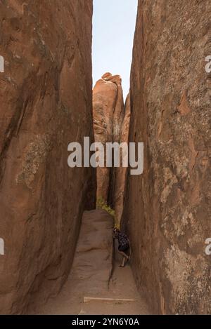 Person fooling around in a narrow gorge in the Arches National Park, USA, North America Stock Photo