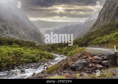 Mountainous Monkey creek flowing through impressive landscape next to Milford Sound highway, South Island of New Zealand Stock Photo