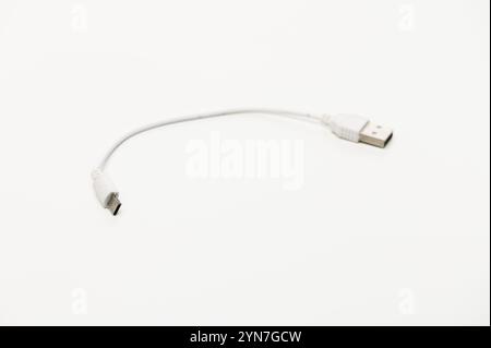 A compact USB cable poised on a clean surface, ready for essential charging and quick data transfer tasks. Stock Photo