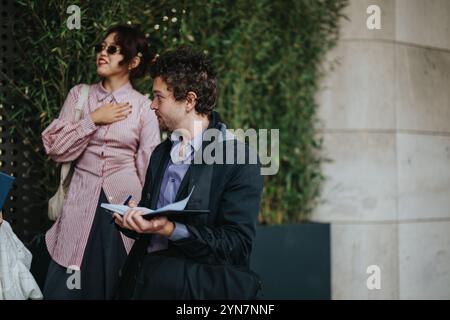 Two business professionals having outdoor discussion with notes Stock Photo